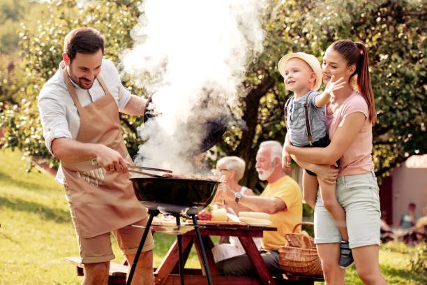 Family having a barbecue party in their garden in summer.